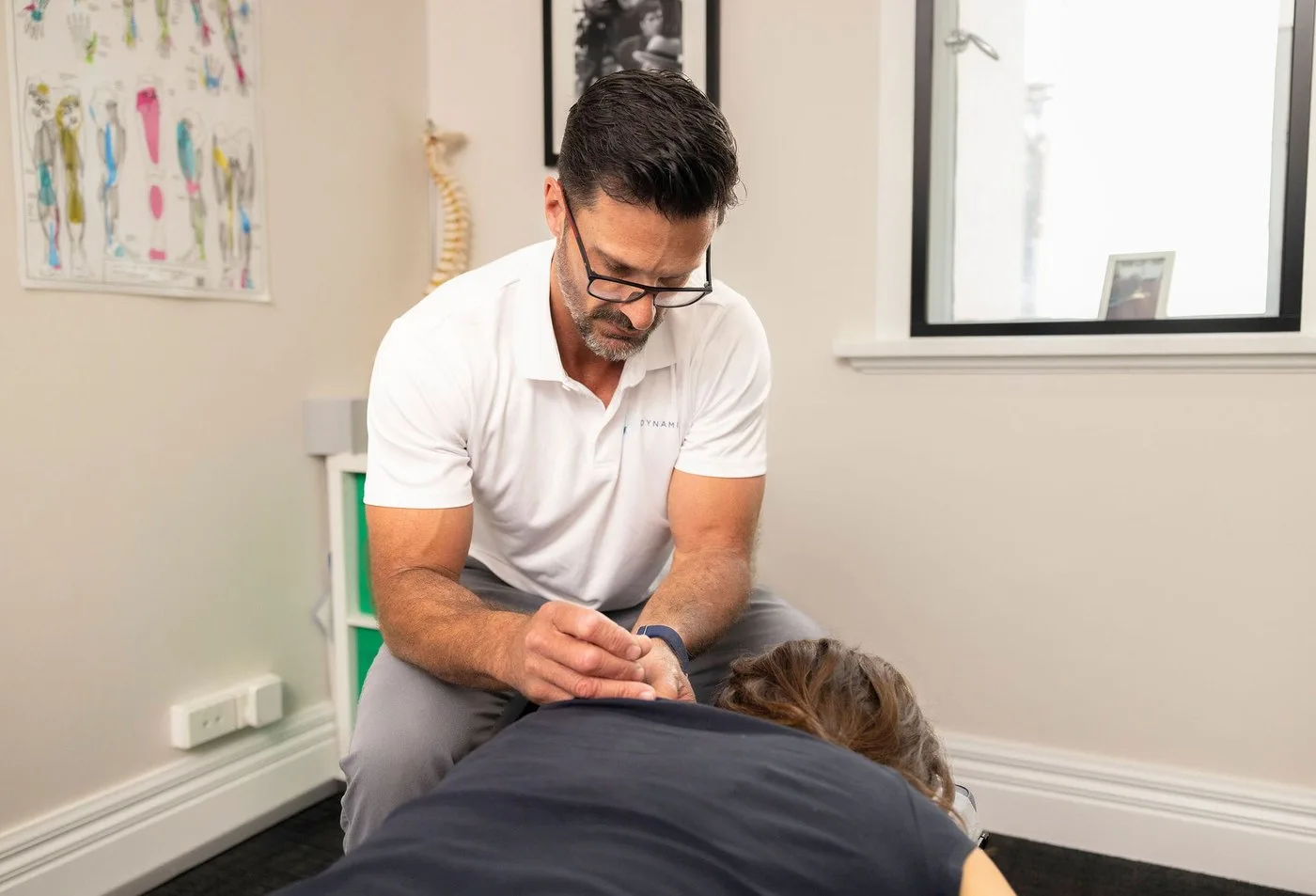 Rob Simms-Reeve performing dry needling on a patient's upper back
